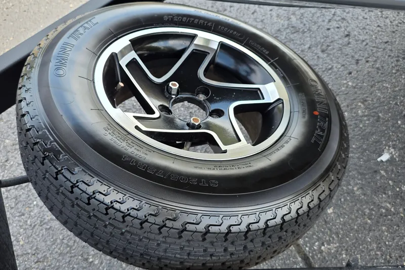 Slide: The Image of 2021 Ranger VS1882 WT wheel with Omni Trail tire on asphalt surface. - 7