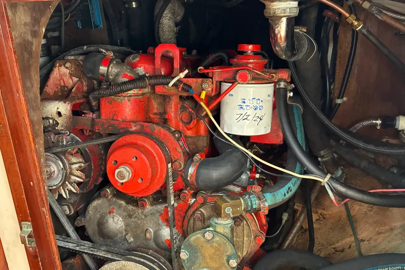 Slide: The Image of Engine compartment of a 1966 Hinckley Bermuda 40 MKIII sailboat, featuring a red engine. - 57