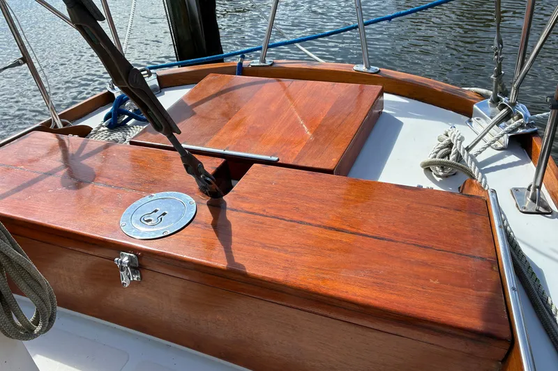 Slide: The Image of Hinckley Bermuda 40 MKIII sailboat deck, showcasing polished wood and nautical ropes, 1966 model. - 13