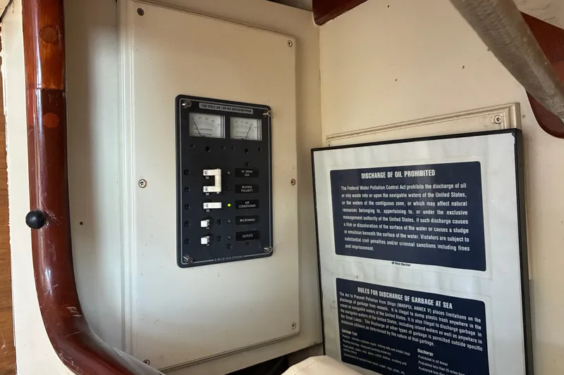 Slide: The Image of Electrical panel and safety notices inside a 1966 Hinckley Bermuda 40 MKIII sailboat. - 24