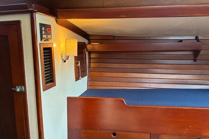 Slide: The Image of Interior of a 1966 Hinckley Bermuda 40 MKIII sailboat with wooden paneling and a cozy berth. - 39