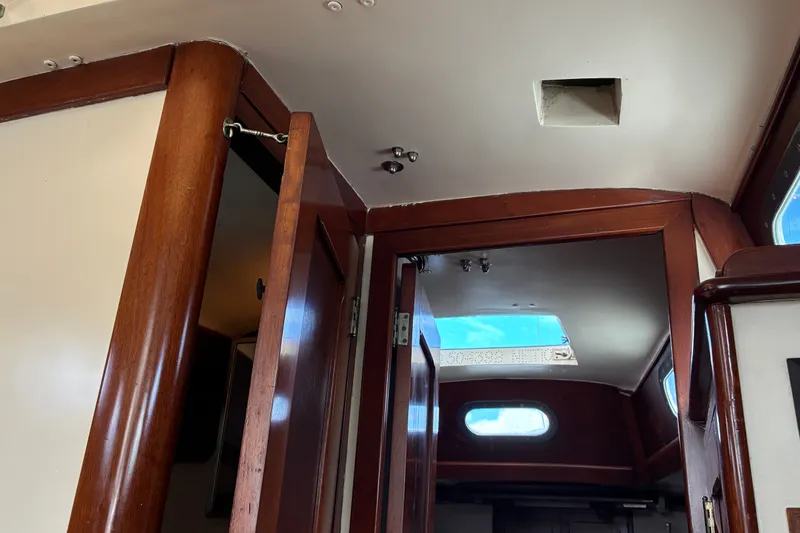 Slide: The Image of Interior view of 1966 Hinckley Bermuda 40 MKIII sailboat with wooden doors and ceiling hatch. - 34