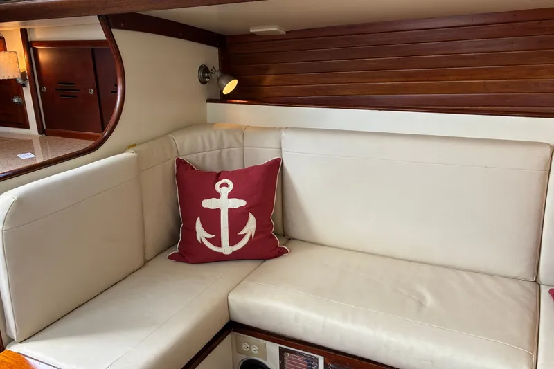 Slide: The Image of Interior of 1966 Hinckley Bermuda 40 MKIII with white seating and anchor-themed pillow. - 32