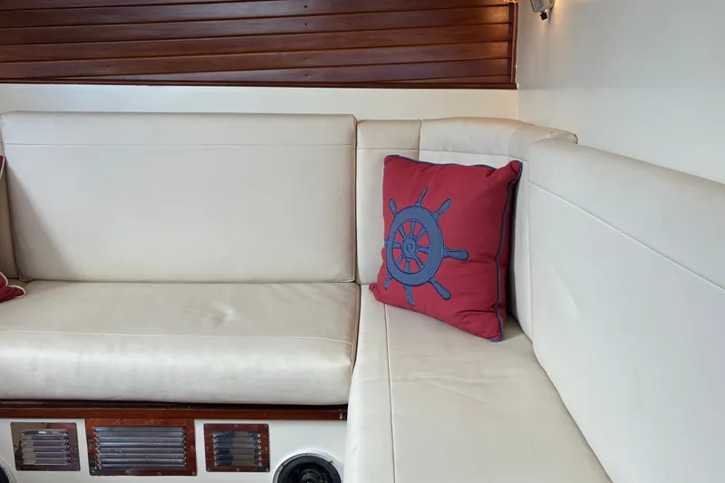 Slide: The Image of Interior of 1966 Hinckley Bermuda 40 MKIII with nautical-themed cushion on white seating. - 33