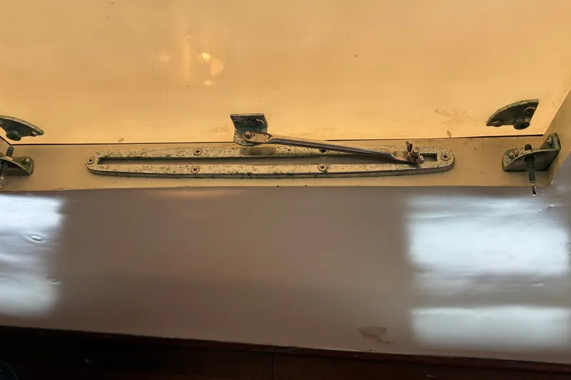 Slide: The Image of Hatch mechanism on a 1966 Hinckley Bermuda 40 MKIII sailboat, showing metal fittings and hinges. - 51