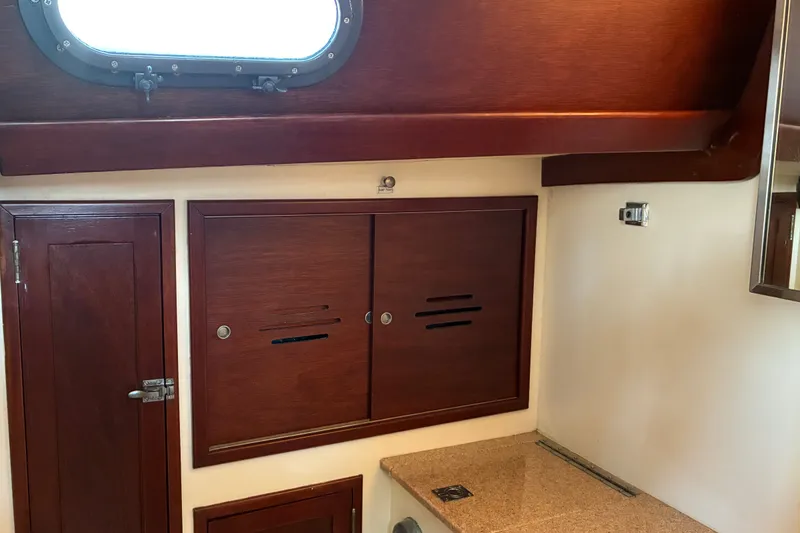 Slide: The Image of Interior of 1966 Hinckley Bermuda 40 MKIII with wooden cabinetry and porthole window. - 47