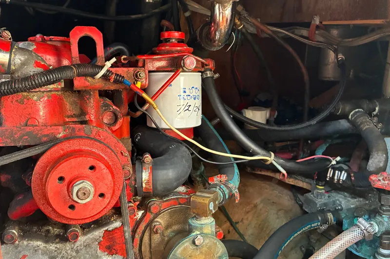 Slide: The Image of Engine compartment of a 1966 Hinckley Bermuda 40 MKIII sailboat, featuring red mechanical components. - 59