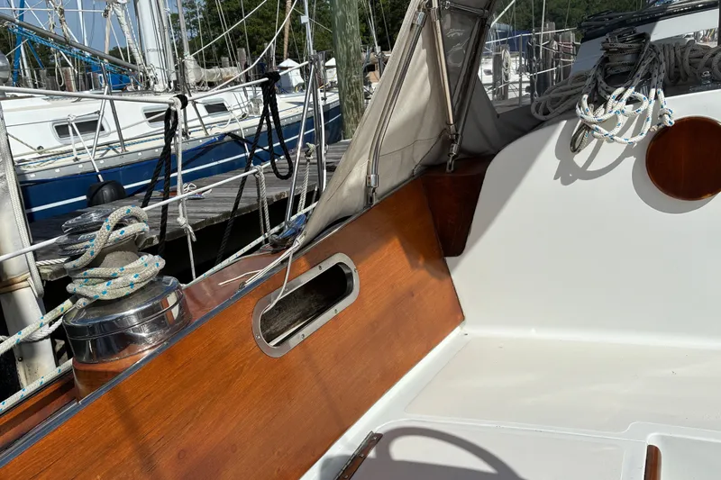 Slide: The Image of Hinckley Bermuda 40 MKIII sailboat cockpit with ropes and wooden trim, docked at marina. - 17