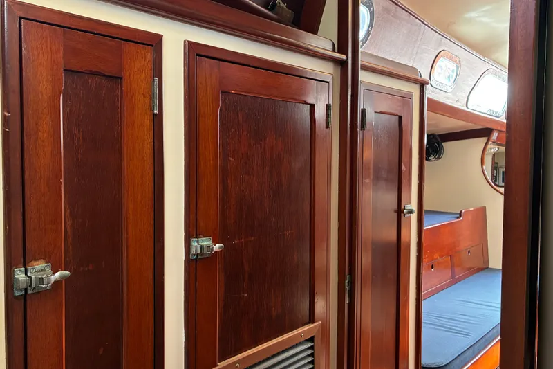 Slide: The Image of Interior of 1966 Hinckley Bermuda 40 MKIII with wooden cabinets and cozy seating area. - 43