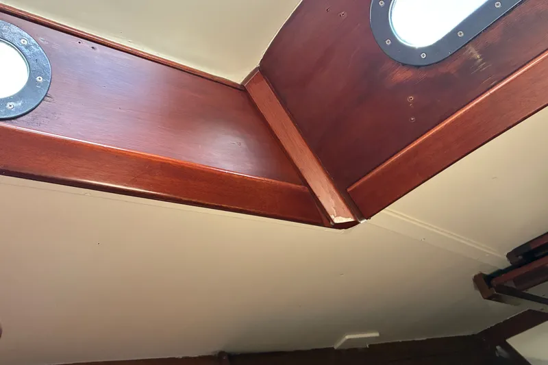 Slide: The Image of Interior view of 1966 Hinckley Bermuda 40 MKIII sailboat with wooden paneling and portholes. - 50