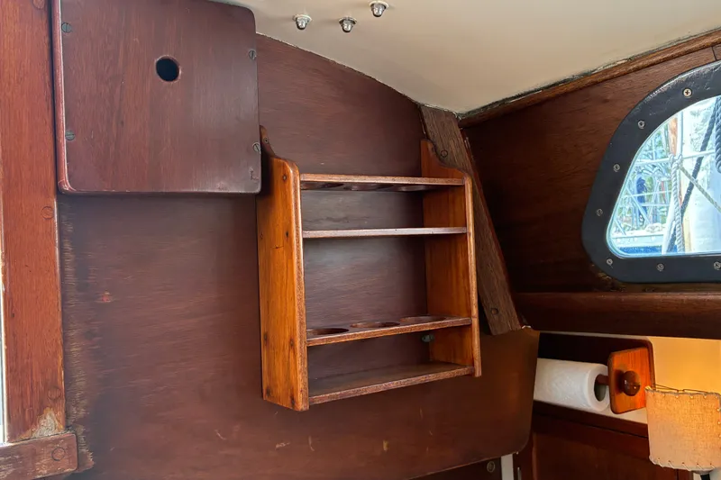 Slide: The Image of Interior of 1966 Hinckley Bermuda 40 MKIII sailboat with wooden shelves and porthole. - 55