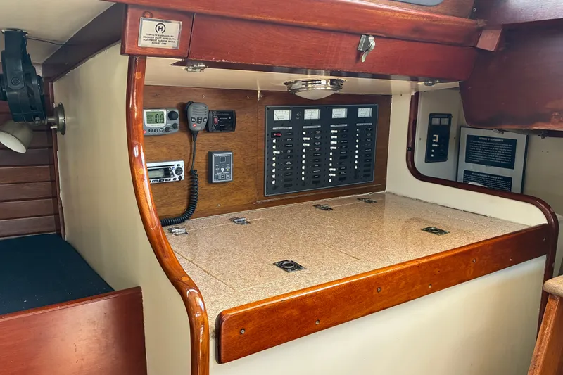 Slide: The Image of Interior view of a 1966 Hinckley Bermuda 40 MKIII sailboat's navigation station with control panels. - 26