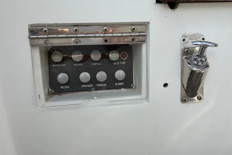 Slide: The Image of Control panel on a 1966 Hinckley Bermuda 40 MKIII sailboat with various switches. - 68
