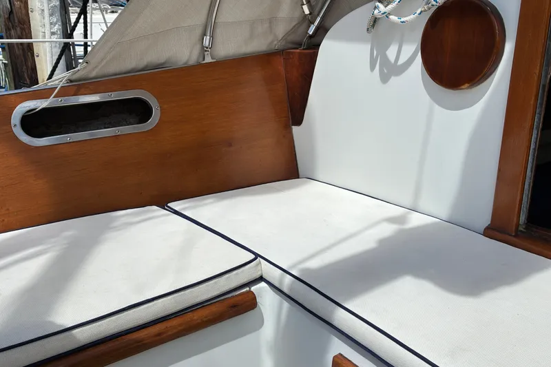 Slide: The Image of Interior seating of 1966 Hinckley Bermuda 40 MKIII sailboat with wooden accents and white cushions. - 61