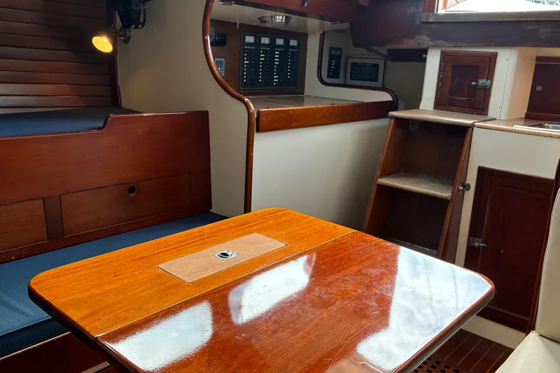 Slide: The Image of Interior of 1966 Hinckley Bermuda 40 MKIII sailboat with wooden table and seating. - 41