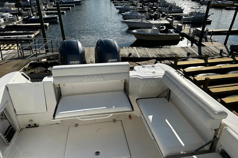 Slide: The Image of 2023 Edgewater 262CX Crossover boat with dual 200 engines docked at marina. - 8