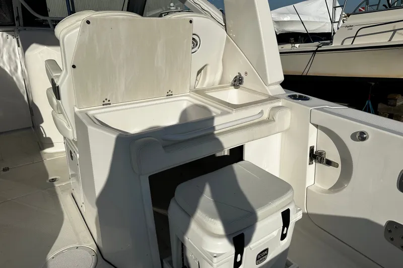 Slide: The Image of 2023 Edgewater 262CX Crossover boat interior with seating and storage area. - 13