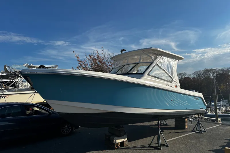 The Image of 2023 Edgewater 262CX Crossover boat on display under clear blue sky. - 1