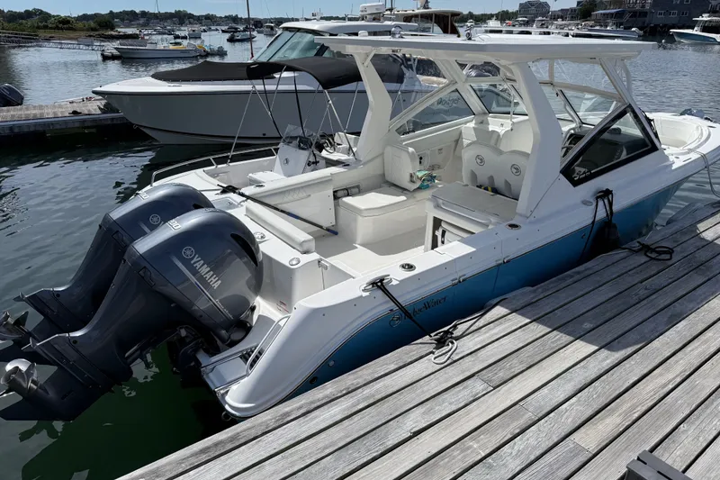 The Image of 2023 Edgewater 262CX Crossover boat docked with twin Yamaha engines. - 1