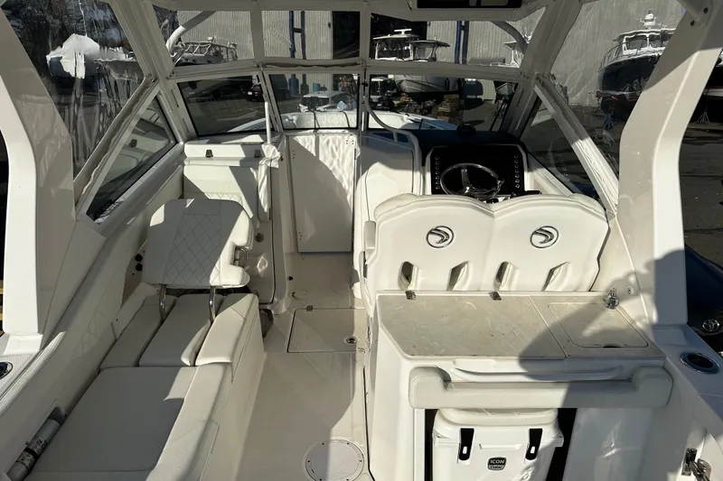 Slide: The Image of 2023 Edgewater 262CX Crossover boat interior with seating and steering wheel. - 18