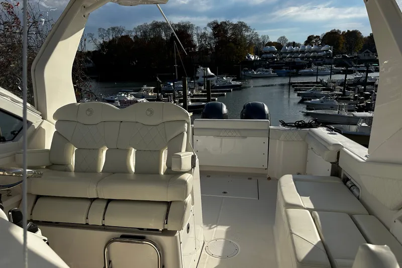 Slide: The Image of 2023 Edgewater 262CX Crossover boat interior with marina view in the background. - 19