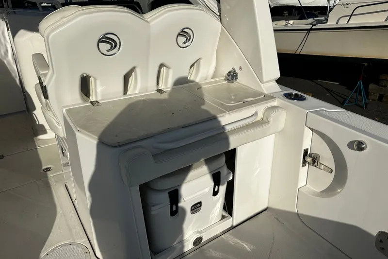 Slide: The Image of 2023 Edgewater 262CX Crossover boat interior with seating and storage area. - 12