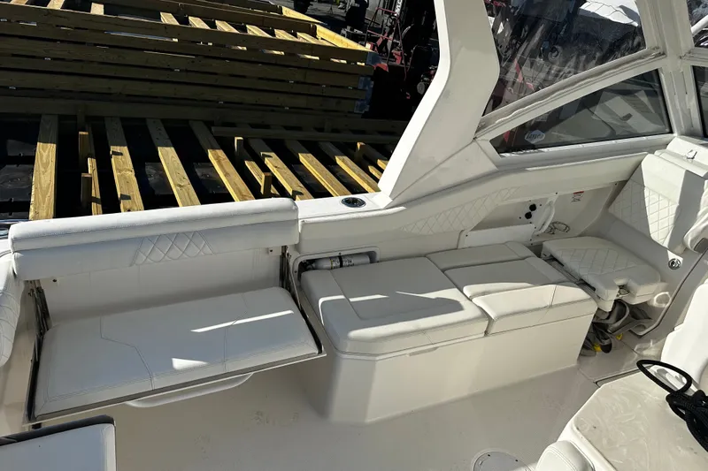 Slide: The Image of Interior of 2023 Edgewater 262CX Crossover boat with white seating and modern design. - 10