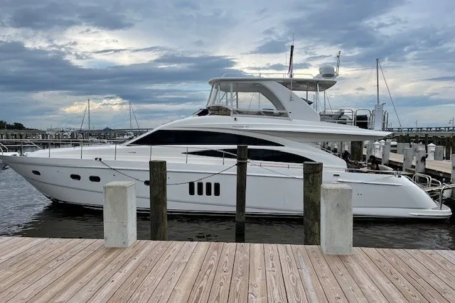 Slide: The Image of 2007 Princess 67 Flybridge Motor Yacht docked at marina under cloudy sky. - 38