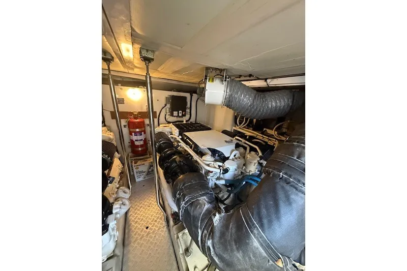 Slide: The Image of Engine room of 2007 Princess 67 Flybridge Motor Yacht, featuring machinery and fire extinguisher. - 34