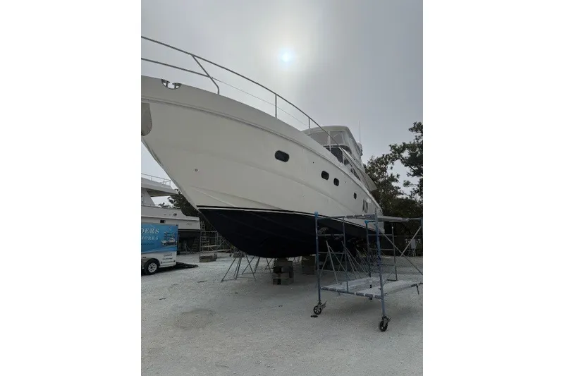 Slide: The Image of 2007 Princess 67 Flybridge Motor Yacht on dry dock, overcast sky. - 42