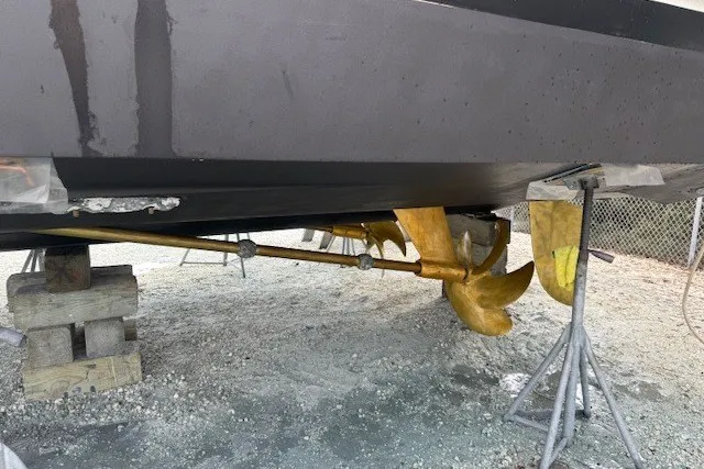 Slide: The Image of 2007 Princess 67 Flybridge Motor Yacht under maintenance, showcasing propellers and hull structure. - 46