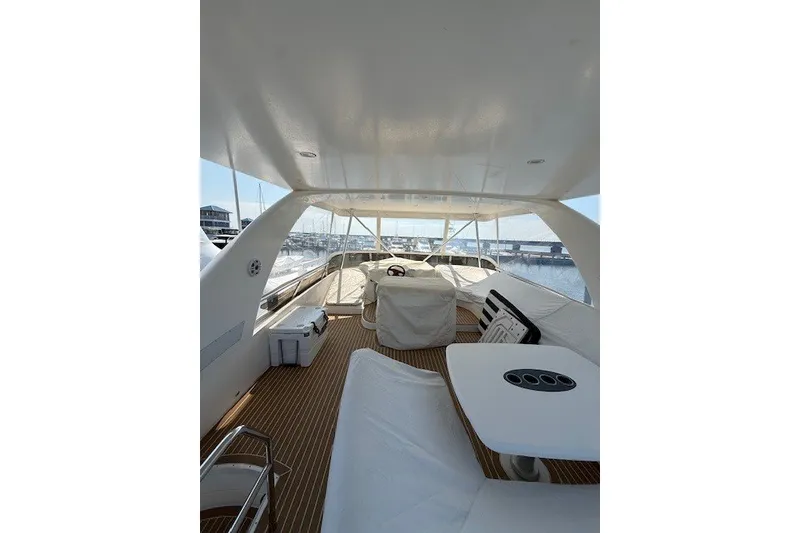 Slide: The Image of Flybridge view of 2007 Princess 67 Motor Yacht with covered seating and steering area. - 20