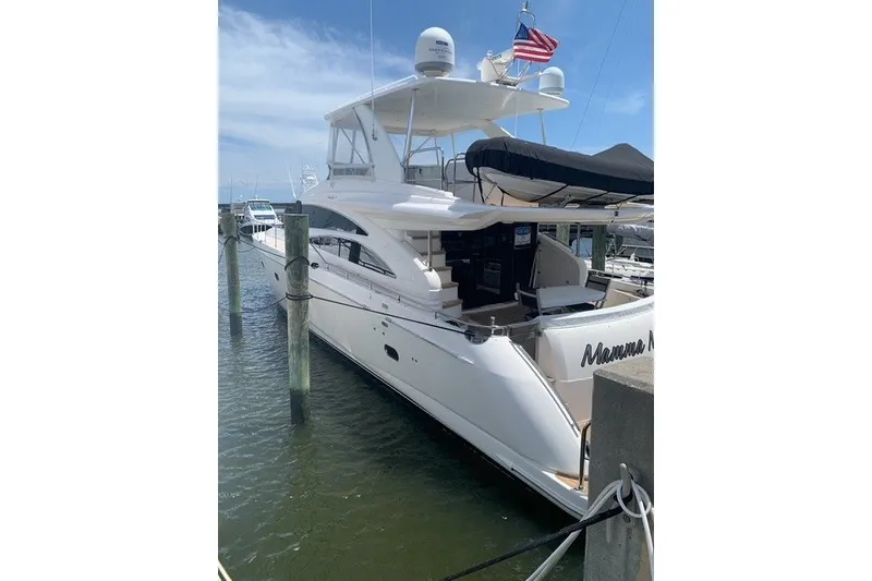 Slide: The Image of 2007 Princess 67 Flybridge Motor Yacht docked at marina, featuring sleek design and spacious deck. - 16
