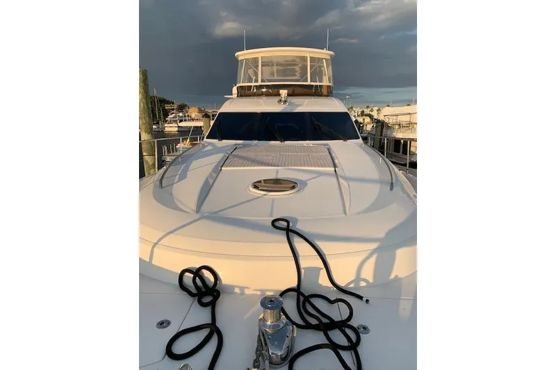 Slide: The Image of 2007 Princess 67 Flybridge Motor Yacht docked, showcasing sleek design and spacious deck. - 17
