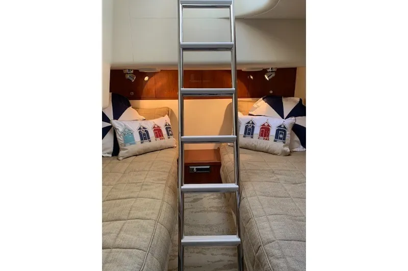 Slide: The Image of Interior of 2007 Princess 67 Flybridge Motor Yacht with twin beds and decorative pillows. - 26