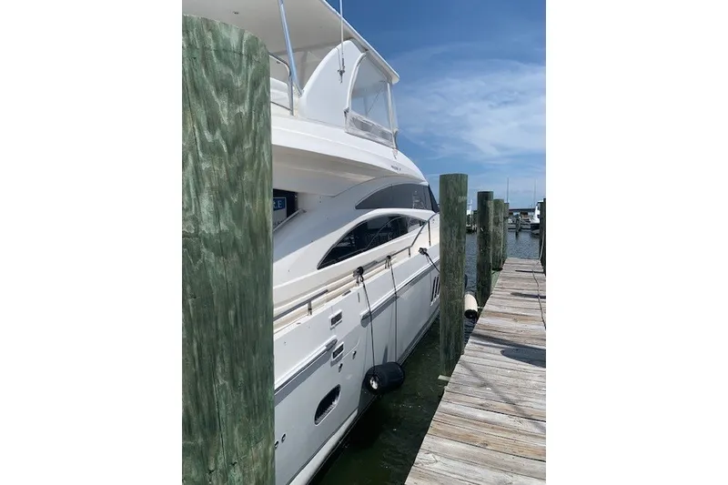 Slide: The Image of 2007 Princess 67 Flybridge Motor Yacht docked at marina under clear sky. - 14