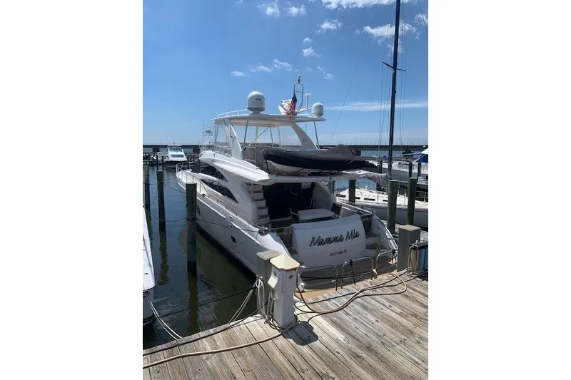 Slide: The Image of 2007 Princess 67 Flybridge Motor Yacht docked at marina under clear blue sky. - 13