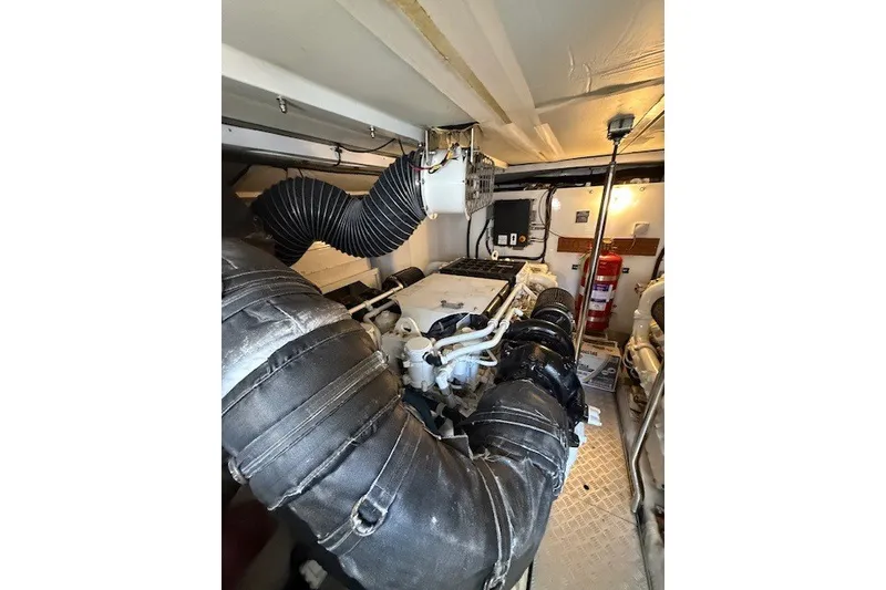 Slide: The Image of Engine room of 2007 Princess 67 Flybridge Motor Yacht, featuring complex machinery and piping. - 35