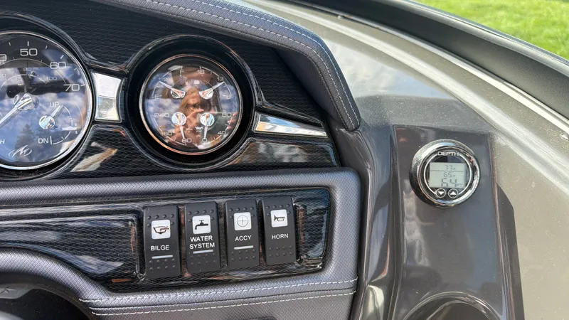 Slide: The Image of Dashboard of a Monterey 224FS boat with gauges and switches. - 43
