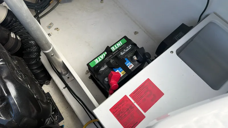Slide: The Image of Battery in a boat engine compartment with cables and hoses. - 27