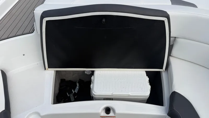 Slide: The Image of An open storage compartment on a boat with a cooler inside. - 23