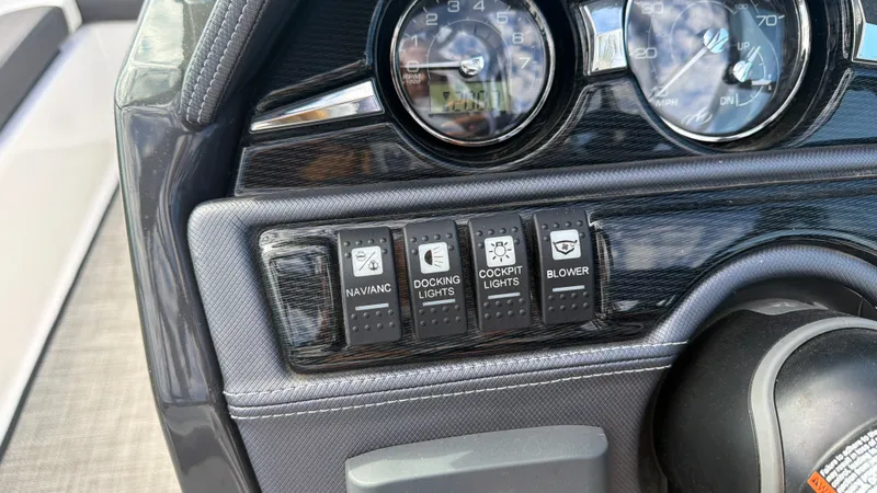 Slide: The Image of Close-up of a 2020 Monterey 224FS dashboard with various switches and gauges. - 46