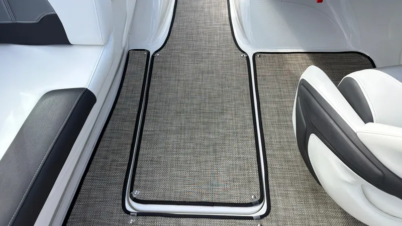 Slide: The Image of Interior of a 2020 Monterey 224FS boat with gray carpeting and white seating. - 48