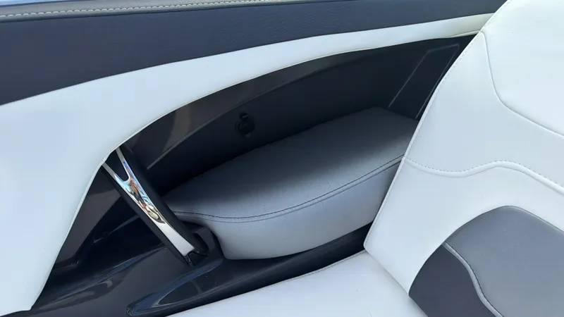 Slide: The Image of Close-up of a white and gray boat seat with armrest and storage compartment. - 33