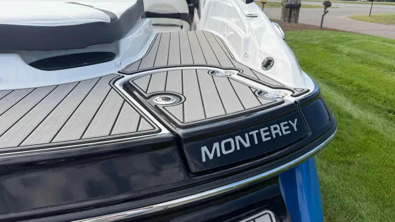 Slide: The Image of Close-up of the stern of a Monterey 224FS boat with gray decking and logo. - 14