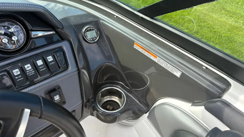 Slide: The Image of Dashboard of a 2020 Monterey 224FS boat with a speedometer and cup holder. - 40