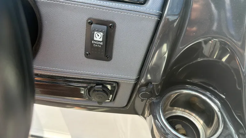 Slide: The Image of Close-up of a Monterey 224FS boat dashboard with engine data display and cup holder. - 42