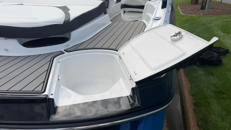 Slide: The Image of The image shows the stern of a 2020 Monterey 224FS boat with an open storage compartment. - 15