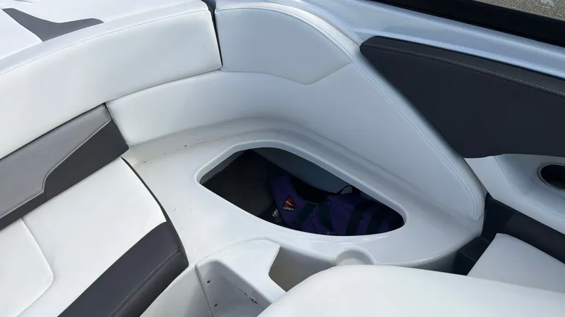 Slide: The Image of The 2020 Monterey 224FS features a white and gray seating area with storage underneath. - 29