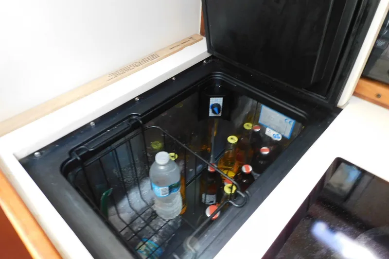 Slide: The Image of Cooler with drinks inside a 2004 Mainship Pilot 30 Rum Runner boat. - 27